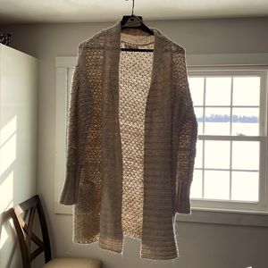 Knitted knee length wool sweater.